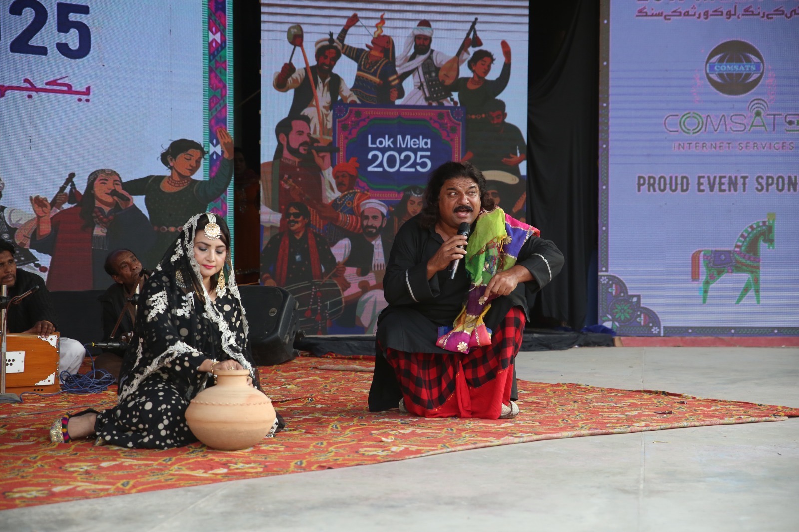 PRESS RELEASE LOK MELA– DCELEBRATES THE MELODIOUS SPIRIT OF AZAD JAMMU & KASHMIR The seventh day of Lok Mela resonated with the soulful rhythms and rich cultural heritage of Azad Jammu & Kashmir (AJK). Thousands of visitors exceeding 200,000 attendees — gathered to witness a mesmerizing celebration of Kashmiri folk traditions, music, and dance at the Open Air Theatre. The highlight of the evening was the Kashmir Musical Night, featuring a lineup of acclaimed Kashmiri artists and folk singers who transported the audience to the scenic valleys of AJK through their melodious performances. Among the performers were Altaf Mir, Ashiq Hussain Butt, Sohail Abbasi, Syed Dilawar Abbas, Nadir Khan, Hina Abbasi, Shakeel Ahmed Mir, Shahzeb Hussain, Sajjad Kashmiri, Natasha Khan, Raja Imran, Basit Sheikh, Noman Saleem, Babar Panjkoti, and Bano Rahmat. Accompanying them on traditional instruments were Anwar Ali (Keyboard), Muhammad Maroof (Tabla), Sunny Gill (Dholak), and Muhammad Badar Khan (Rubab) — whose rhythmic beats and soulful tunes added depth to the night’s musical aura. The performances beautifully reflected the cultural richness, linguistic diversity, and musical legacy of Kashmir — blending folk, pahari, sufiana, and gojri traditions into an unforgettable concert of unity and artistry. Audiences responded with heartfelt applause, celebrating Pakistan’s diversity under the theme of “Unity in Colors – Lok Virsa ka Sang.” Throughout the day, visitors enjoyed artisan stalls, traditional cuisines, puppet shows, and cultural pavilions showcasing the heritage of all provinces. The Kashmir Pavilion drew particular admiration for its intricate hand embroidery, wooden craftwork, and regional delicacies. Executive Director Dr. Muhammad Waqas Saleem expressed pride in the overwhelming participation, noting that “Lok Mela brings together Pakistan’s living heritage — reminding us that our cultural diversity is our greatest strength.” Lok Mela continues to welcome the public daily from 10:00 AM to 10:00 PM at Lok Virsa until 16 November 2025.